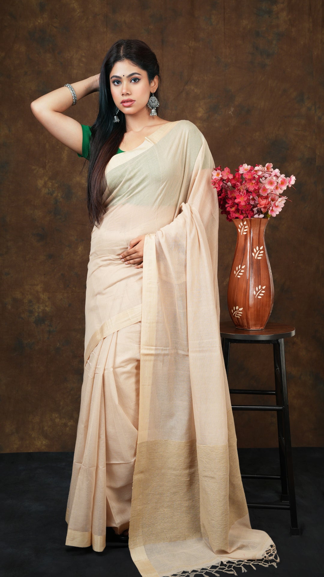Beige soft cotton tangail saree with tassar border and jute-woven pallu. Includes 0.8m running blouse piece. 5.5 meters.