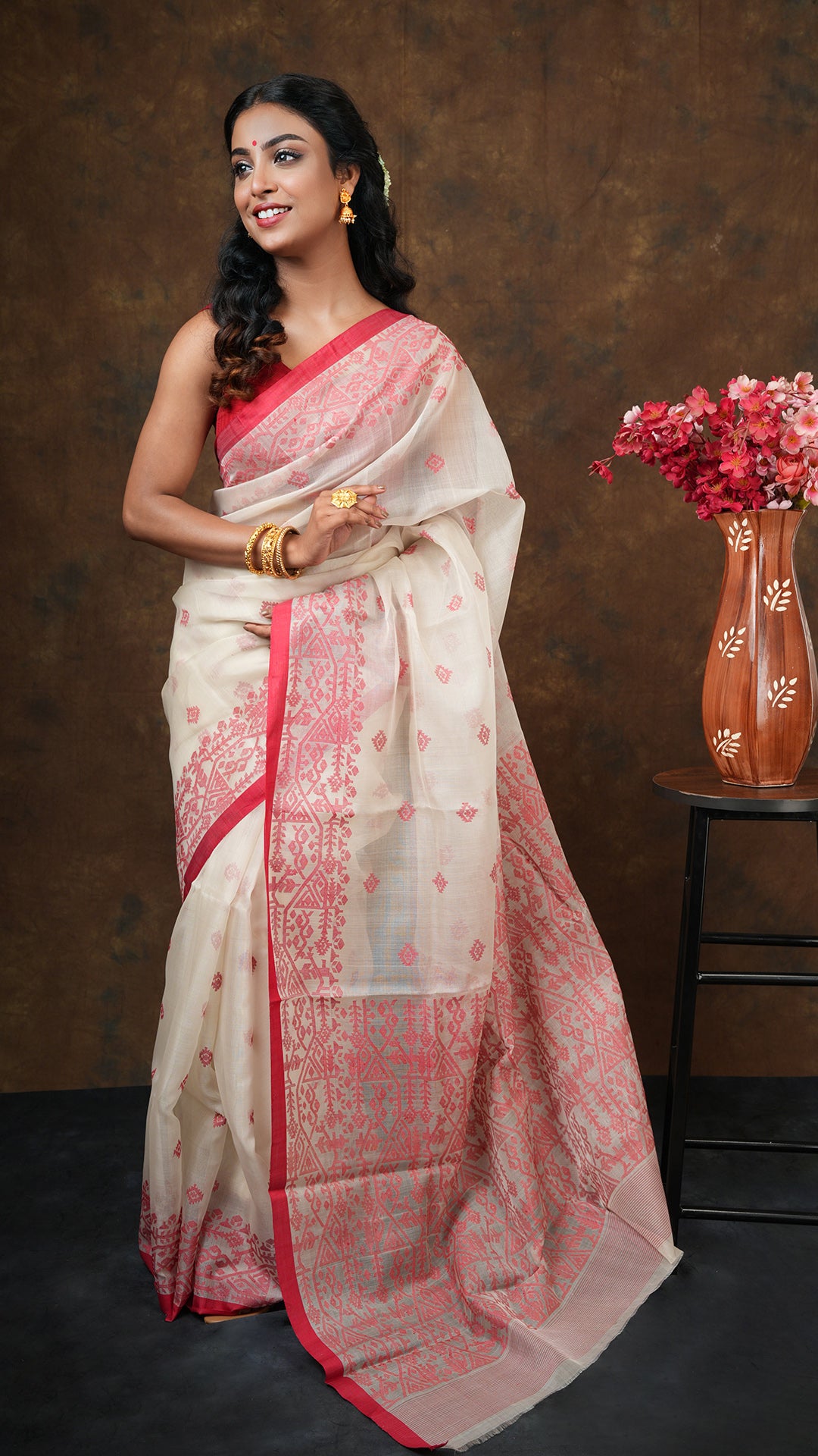 Off white muslin silk dhakai saree with red woven border, butis, and pallu. 5.5 meters with 0.8m running blouse piece