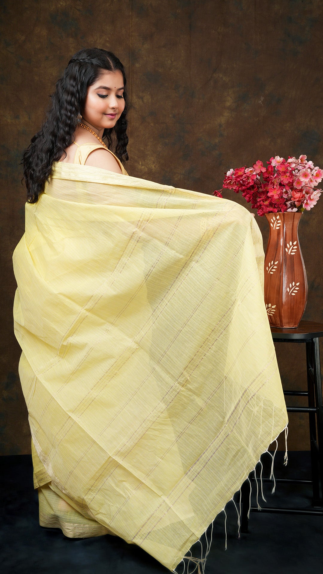 A lemon yellow tangail saree