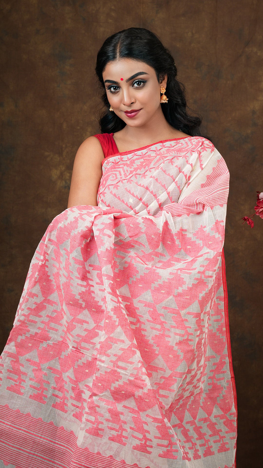 Traditional off white cotton jamdani saree with red and golden zari diagonal weave. Includes 0.8m separate blouse piece. 5.5 meters.