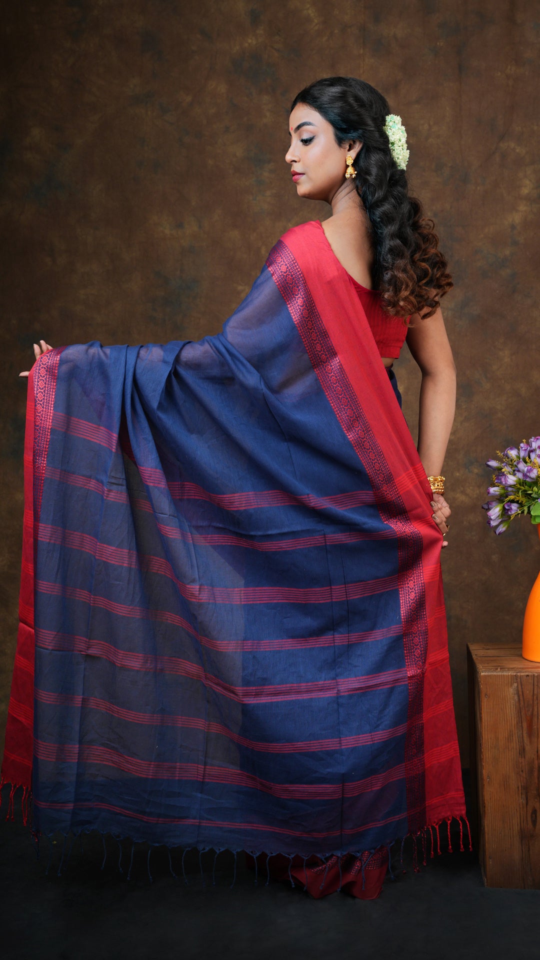 A navy blue with red tangail saree
