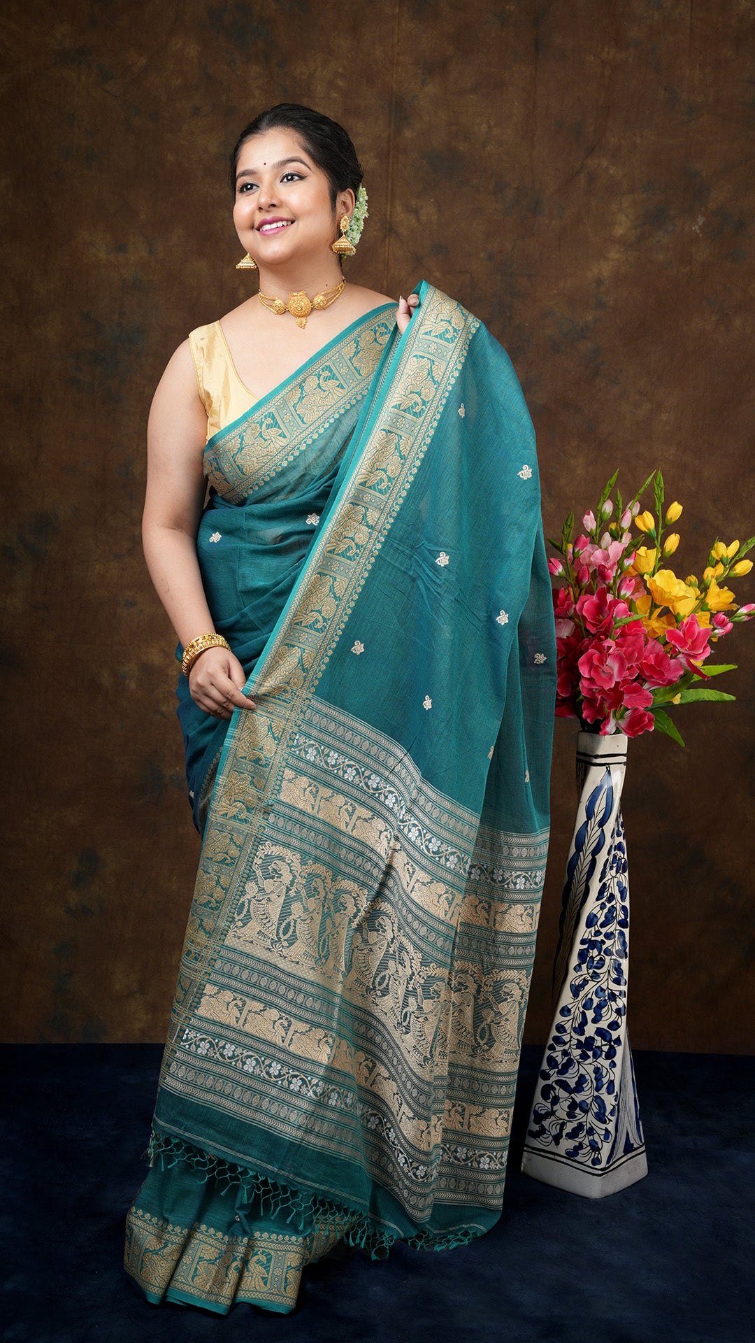 "A dual tone green colour saree        A soft cotton baluchari saree in dual tone green colour. The border and pallu have figures woven in beize. The butis are floral.                Tangail, tant, baluchari        Soft cotton        Soft cotton        5.5 mts        Has blouse piece, 0.80 mts, running
A pink linen saree        A linen saree in pink colour. The border is flat golden. The butis and pallu are woven in white.                Tant, dhakai        Linen        Linen        5.5 mts        Has blous