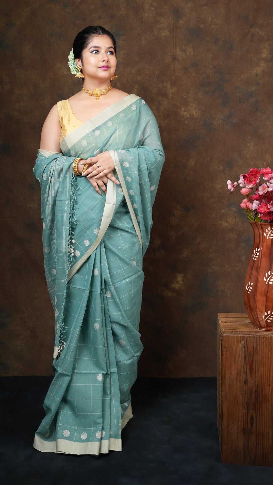 A green check tangail saree - A green tangail saree with woven checks and beige motifs on the border and pallu. This traditional Tangail saree, soft cotton saree, Jaquard weave saree is ideal for cultural wear.