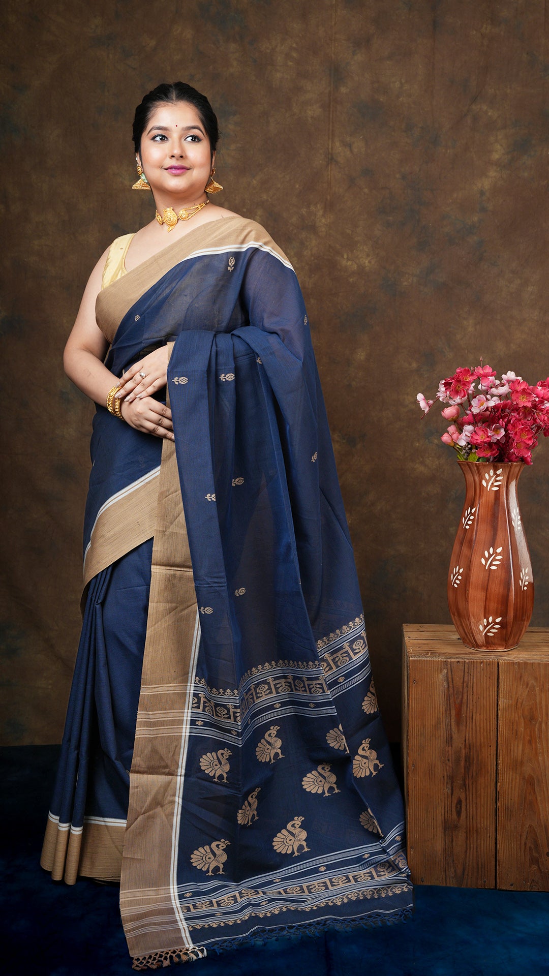 A navy blue tangail saree - A navy blue soft cotton tangail saree with flat beige border and beige-woven butis and pallu. This classic Tangail saree, Jaquard saree is perfect for everyday traditional wear.
