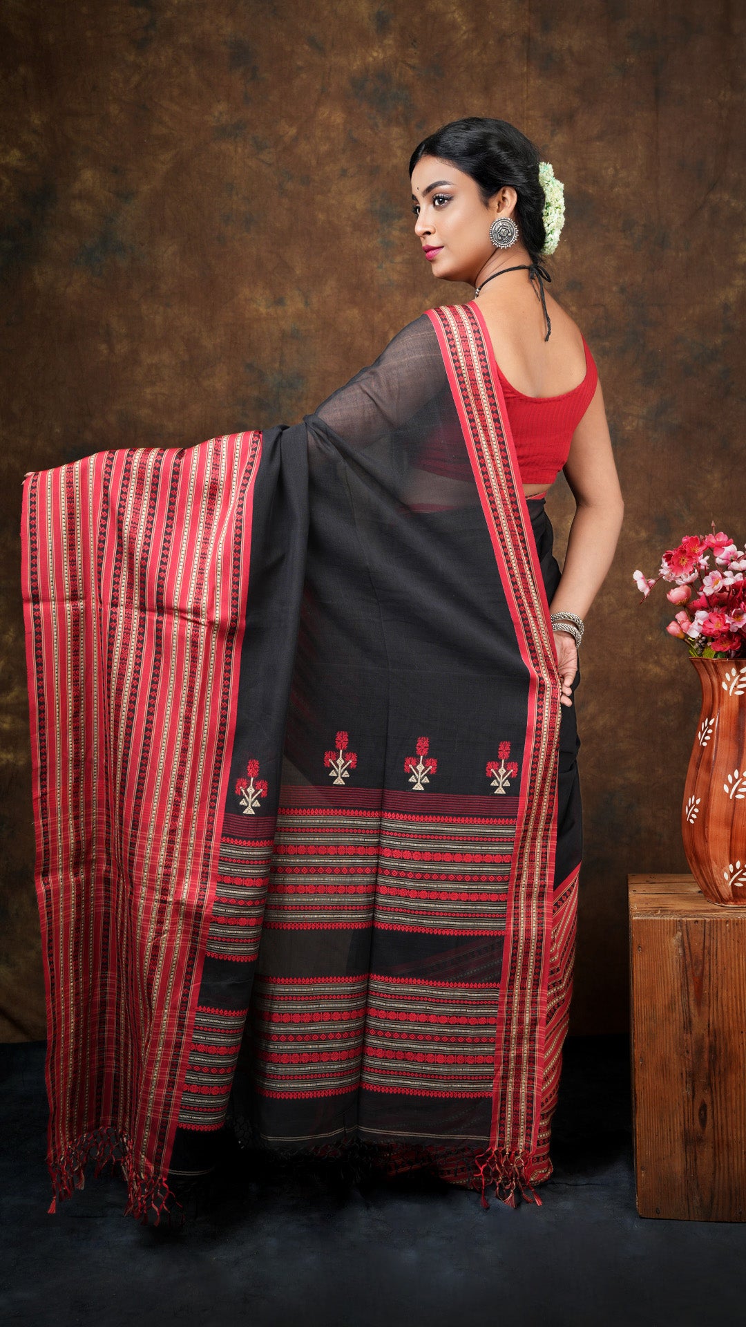 A black and red tangail saree