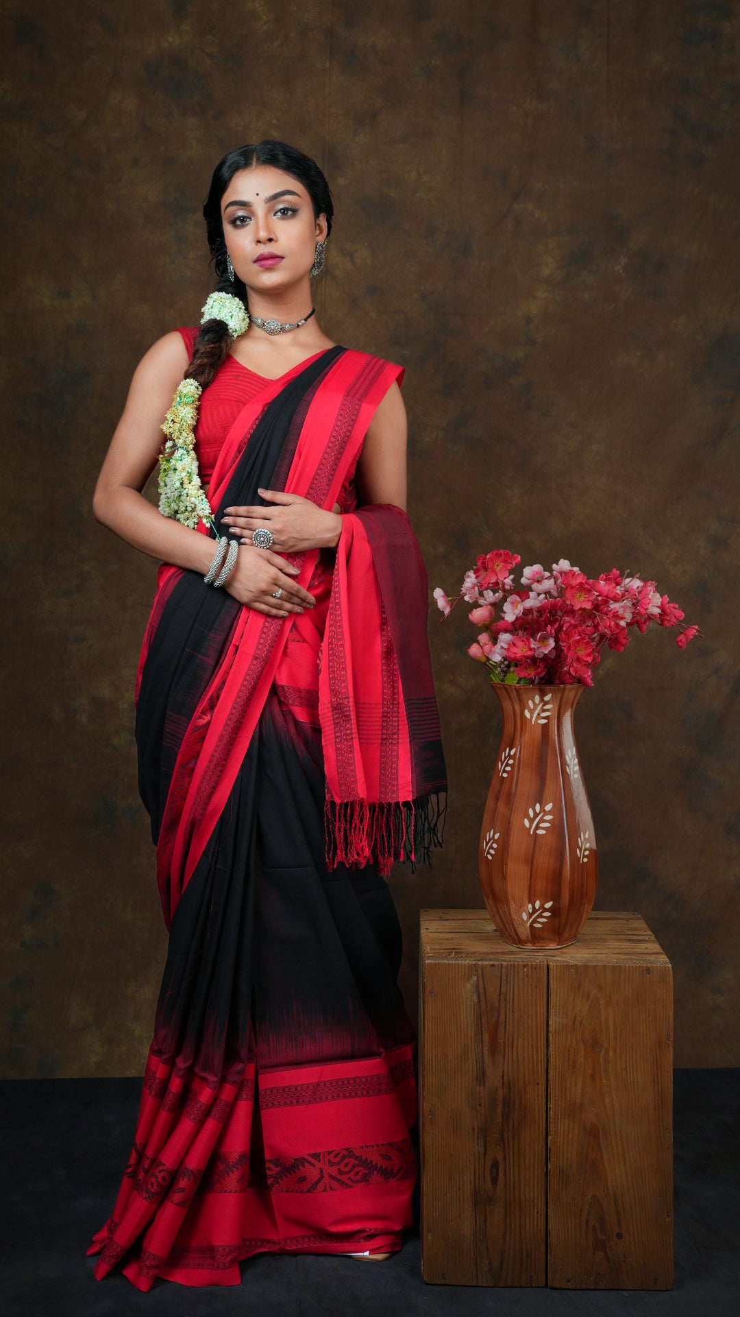 A black tangail saree with red border - A black tangail saree in soft cotton with wide red woven borders and striped pallu. This traditional Tangail saree is ideal for cultural wear.