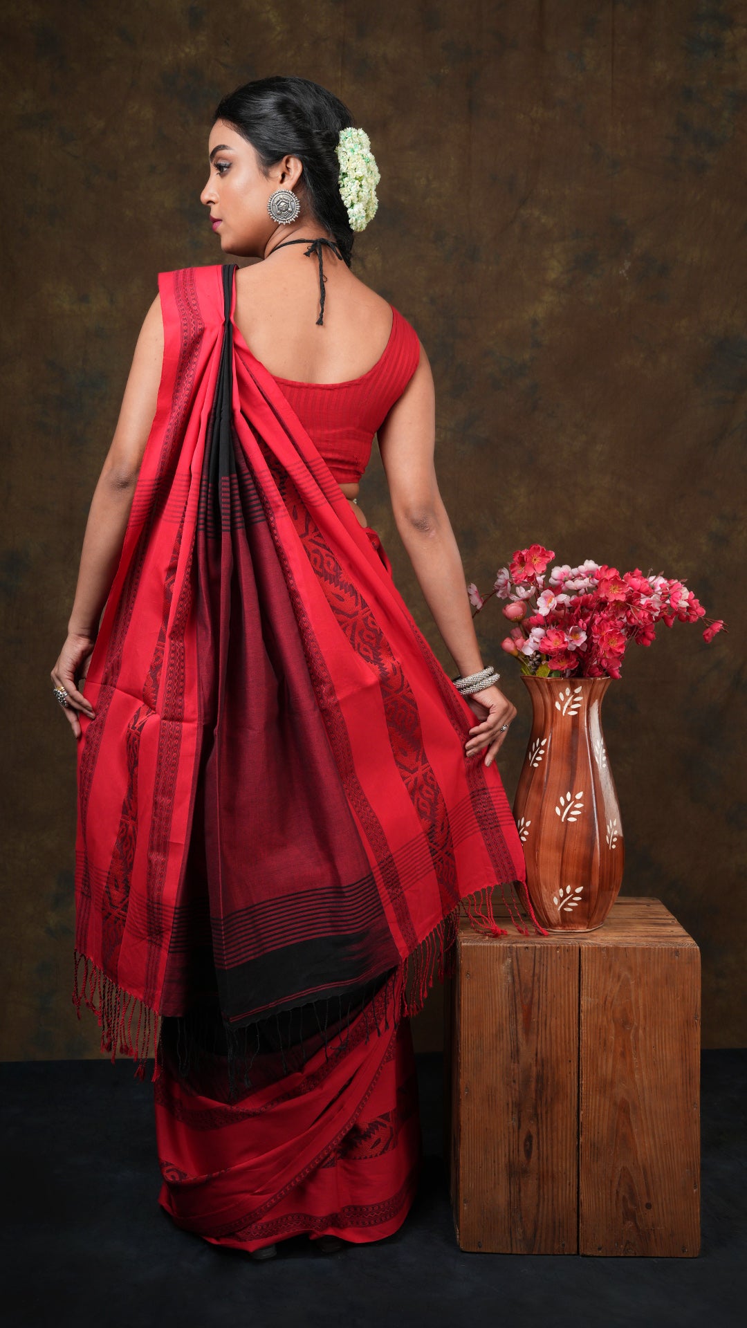 A black tangail saree with red border