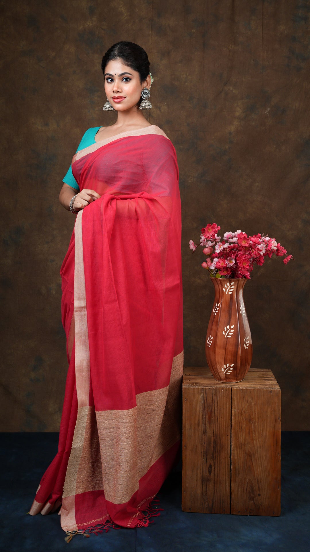 A red striped tangail saree - A red soft cotton tangail saree with self stripes, flat tassar border, and jute-woven pallu. This traditional Tangail saree is a classy handloom pick.