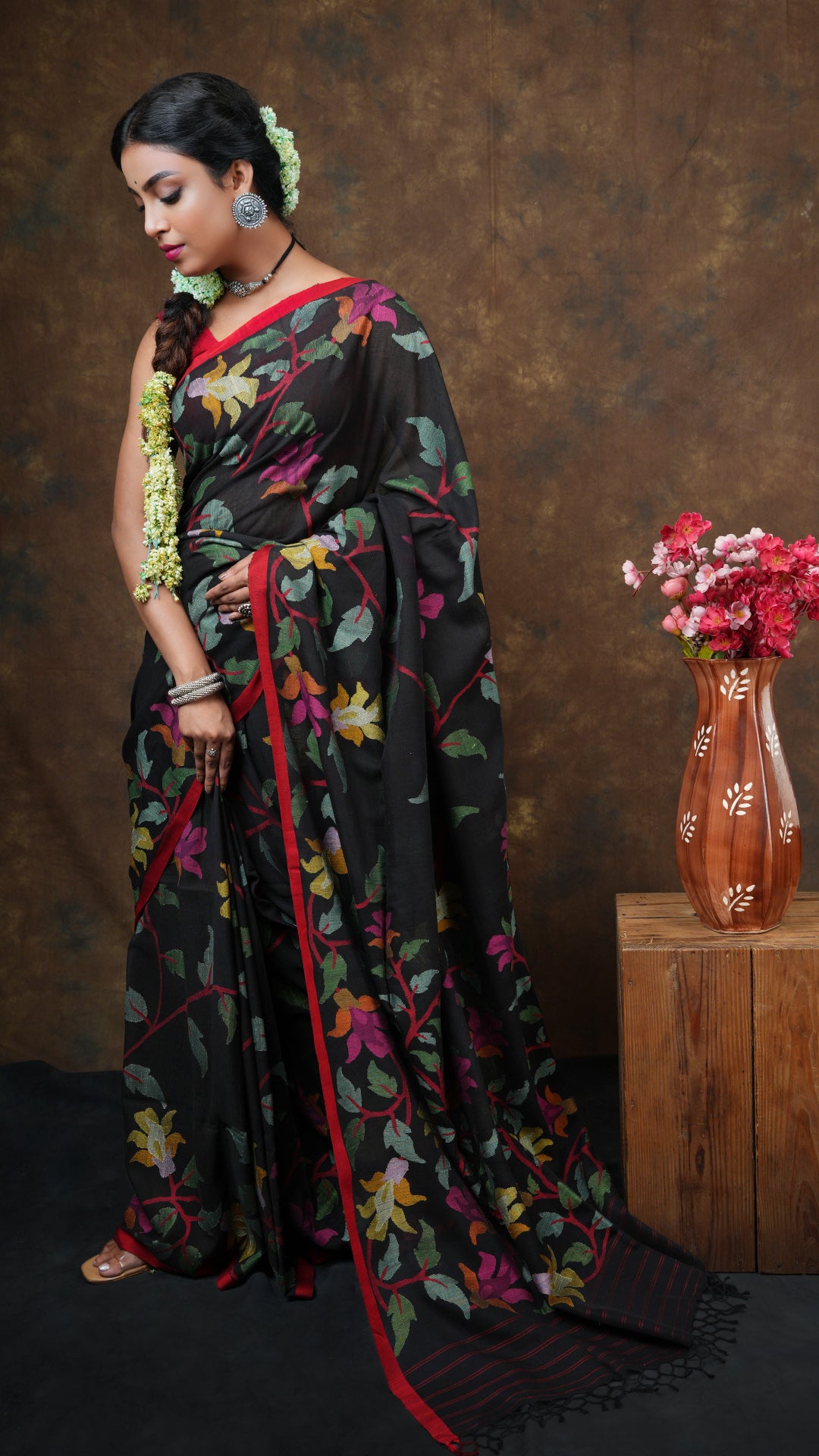 A black with multi coloured dhakai
