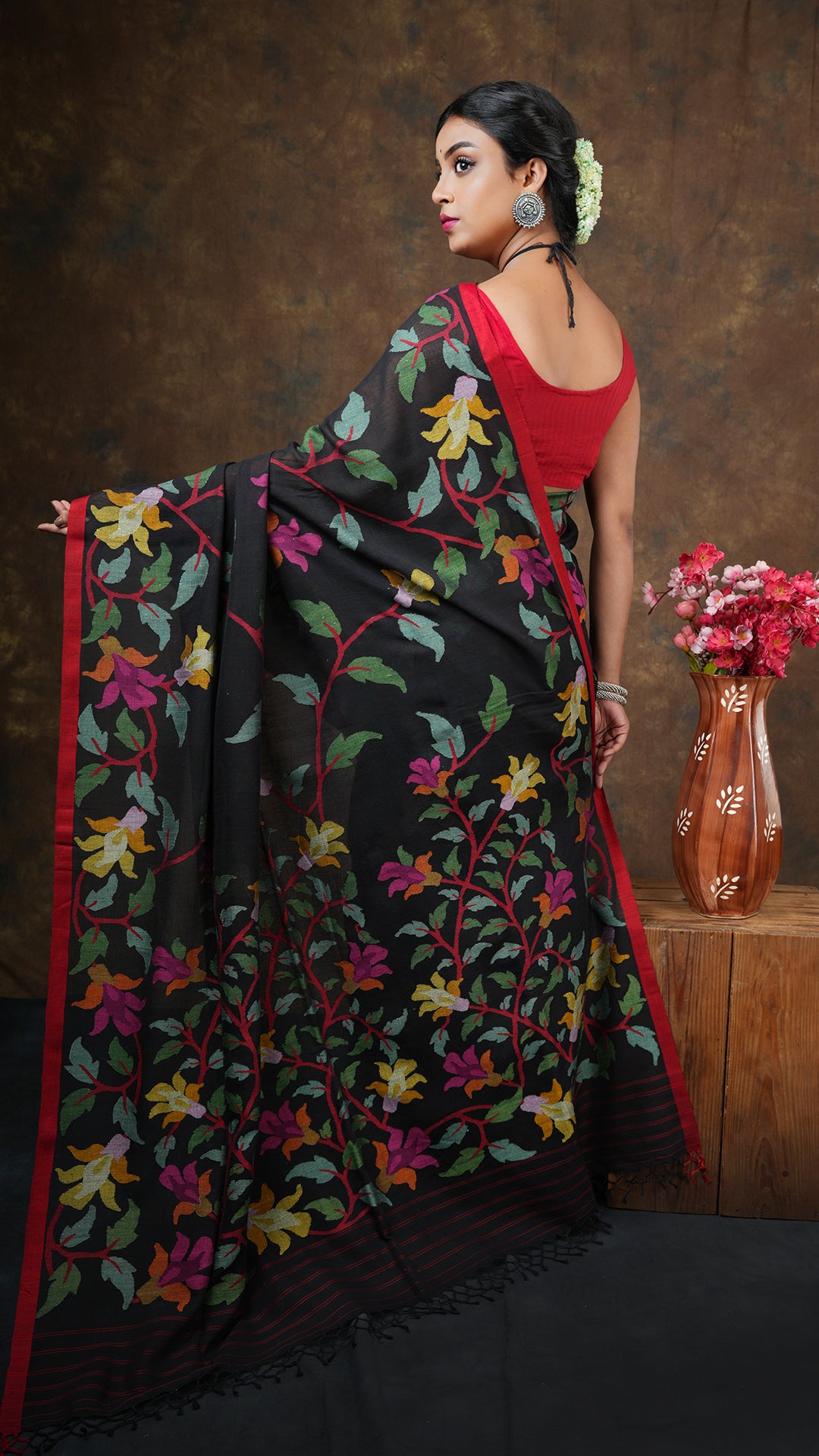 A black with multi coloured dhakai