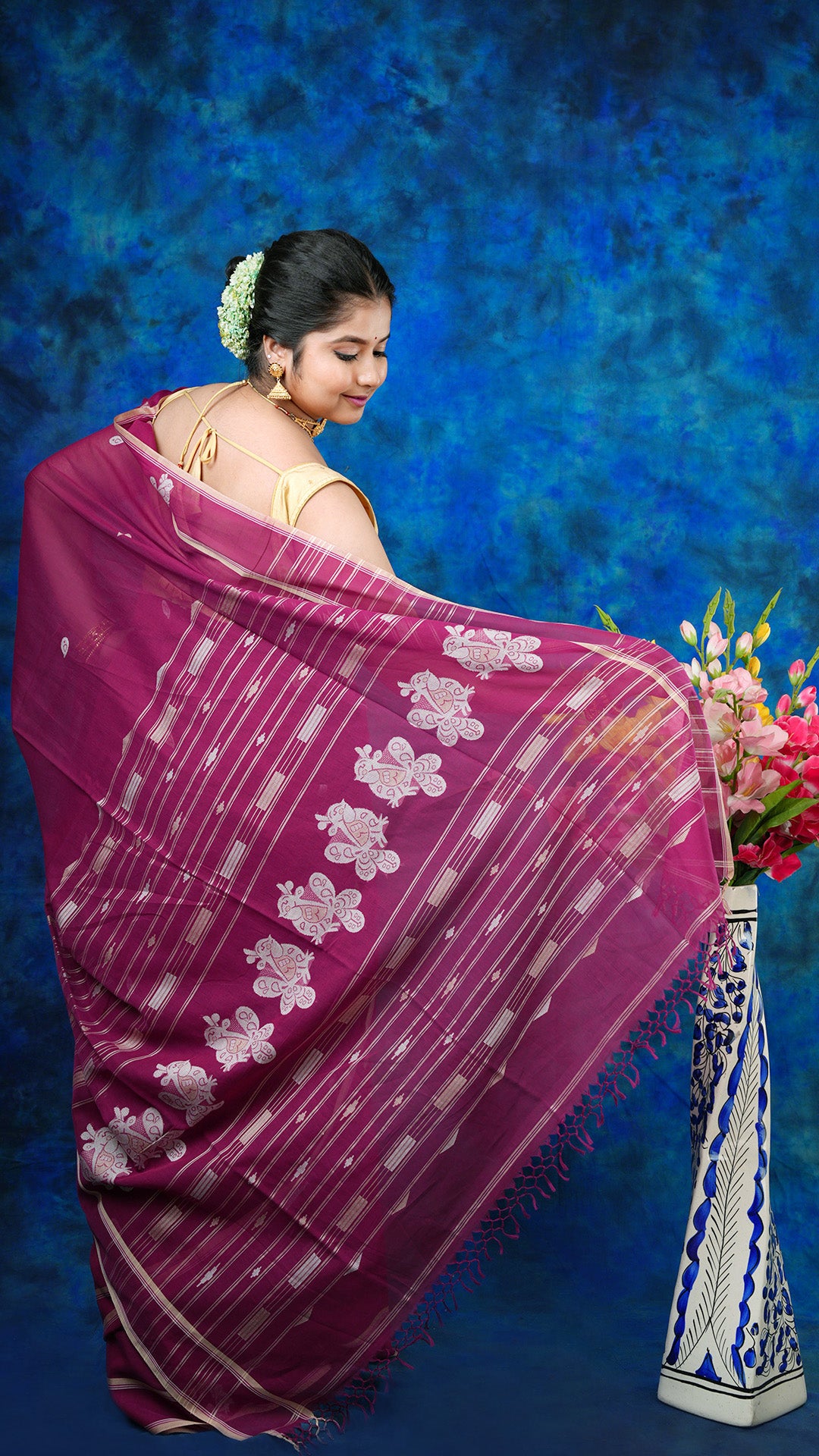 A magenta coloured tangail saree