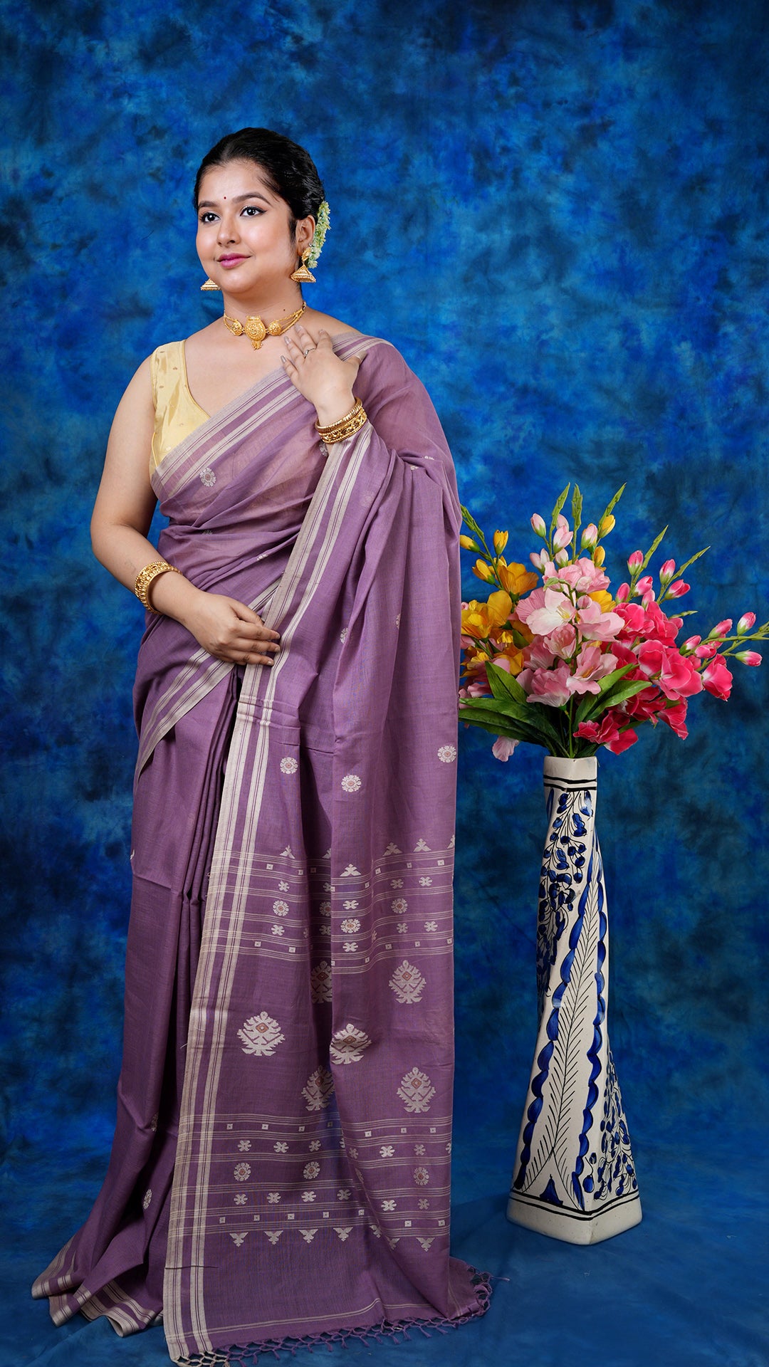 A deep mauve with beige tangail - A deep mauve soft cotton tangail saree with beige butis and pallu. This traditional Tangail saree is ideal for elegant ethnic styling.