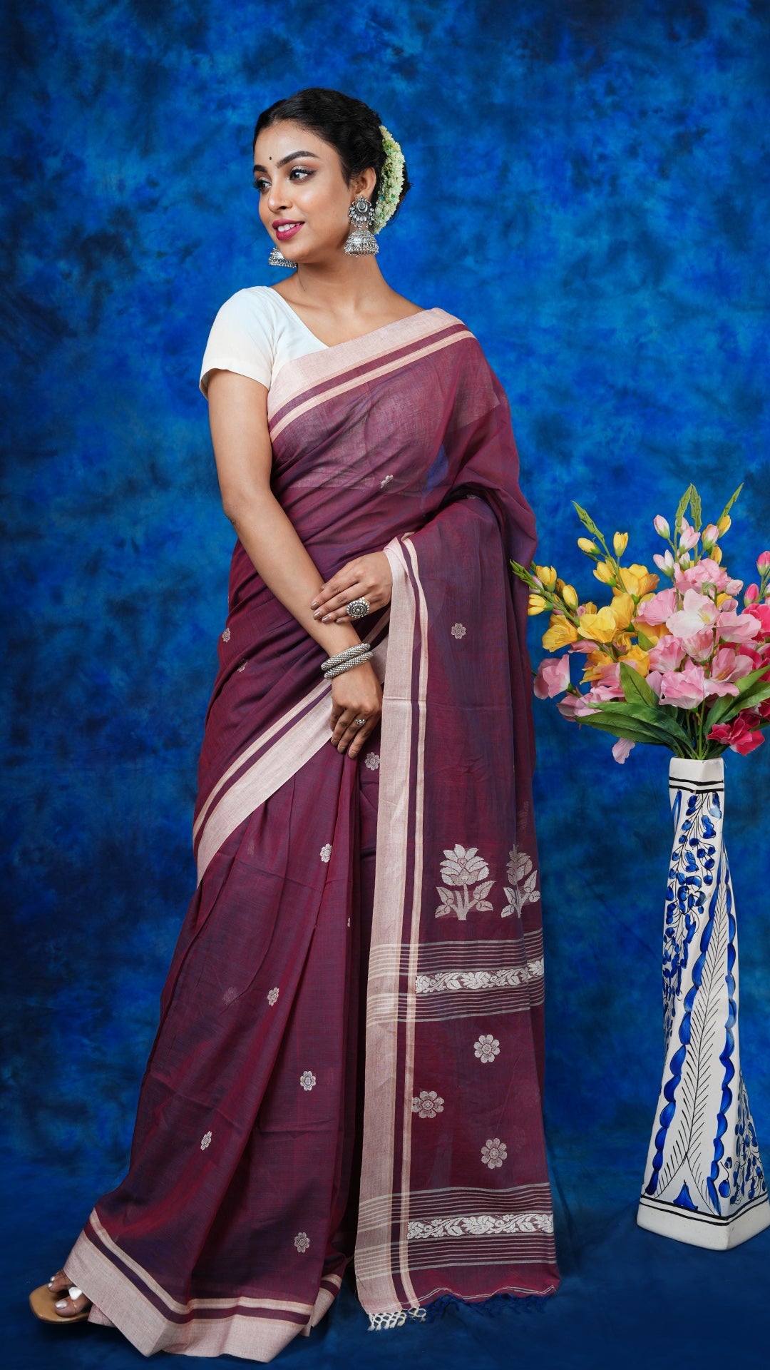 A dual tone mauve tangail saree - A soft cotton dual tone mauve saree with beige borders and off-white woven motifs. This beautiful Tangail saree is ideal for festive dressing