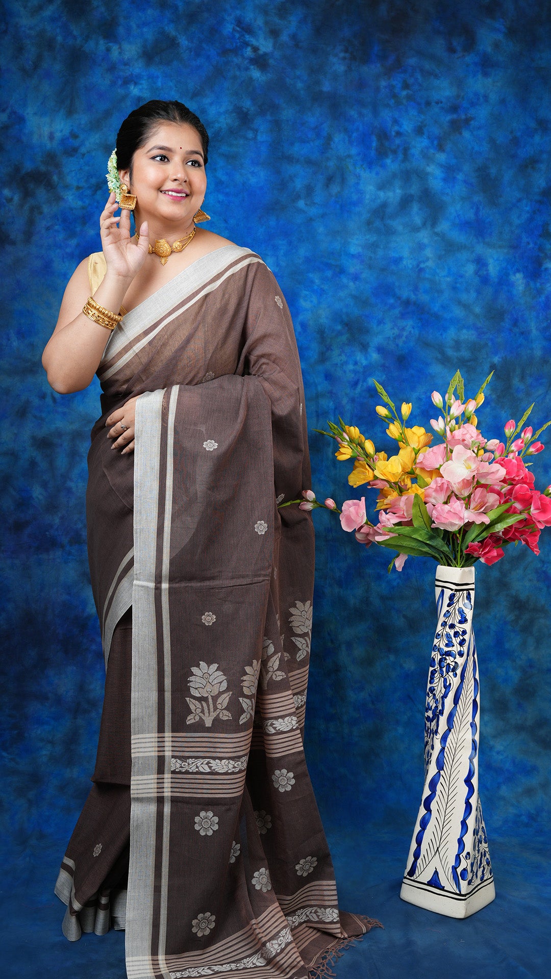 A brown tangail saree - A brown soft cotton tangail saree with off-white and beige motifs on border and pallu. This subtle Tangail saree is perfect for earthy traditional vibes.