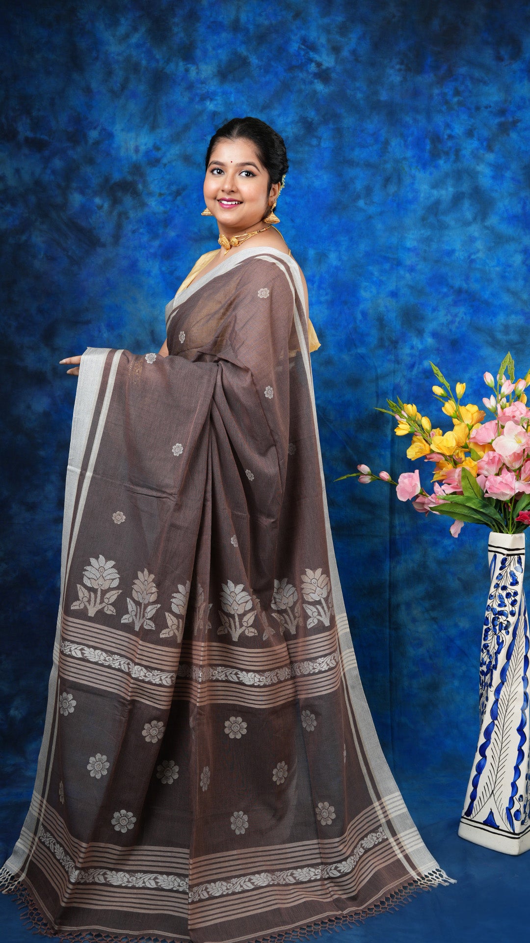 A brown tangail saree - A brown soft cotton tangail saree with off-white and beige motifs on border and pallu. This subtle Tangail saree is perfect for earthy traditional vibes.