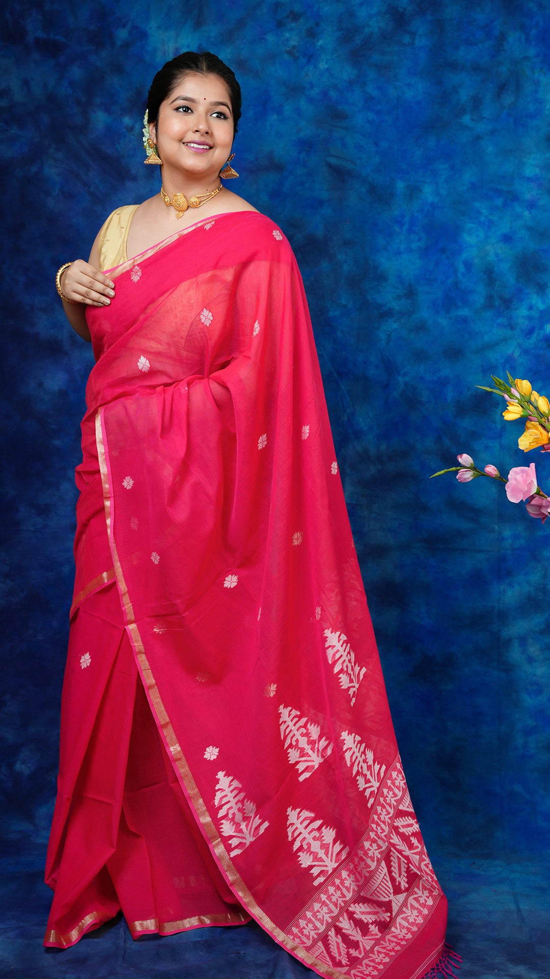 A pink zari bordered tangail saree - A pink soft cotton tangail saree with flat zari borders and white butis. This rich Tangail saree is ideal for cultural gatherings.