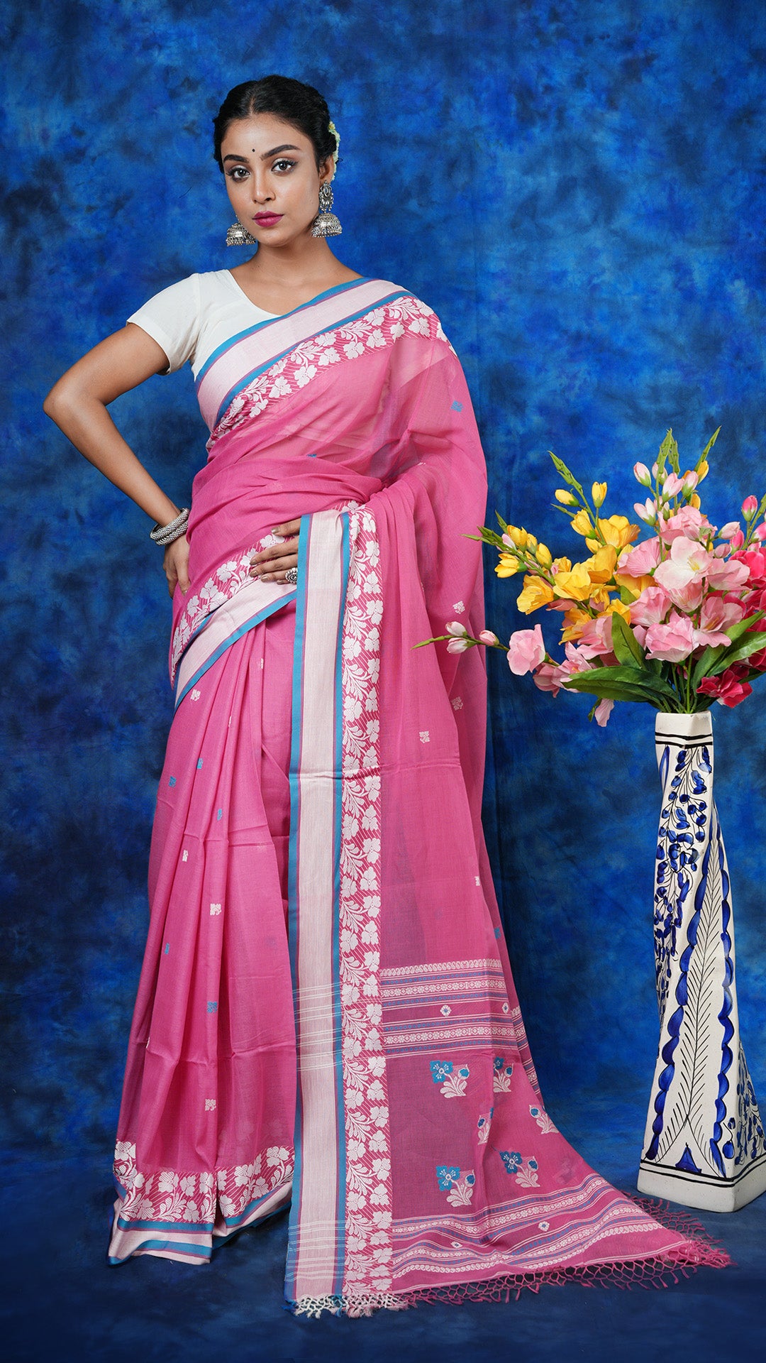 A mauvish pink tangail saree - A mauvish pink soft cotton tangail saree with white and blue woven motifs. This fresh Tangail saree is ideal for day events.