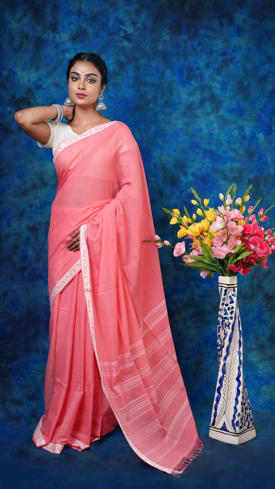 A peach and white tangail saree - A peach soft cotton tangail saree with small white border and striped pallu. This light Tangail saree is perfect for a summer ethnic look.