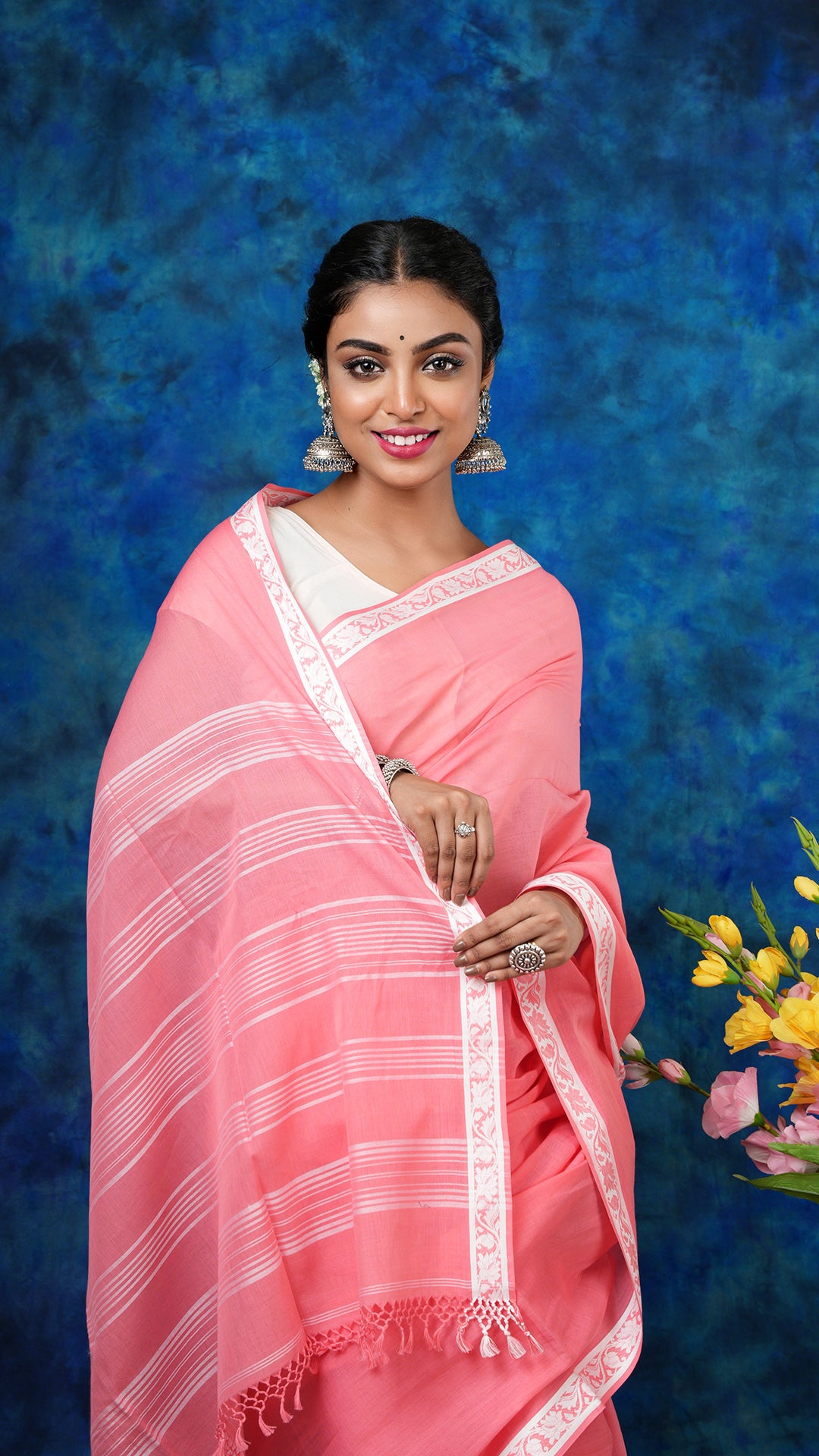 A peach and white tangail saree - A peach soft cotton tangail saree with small white border and striped pallu. This light Tangail saree is perfect for a summer ethnic look.