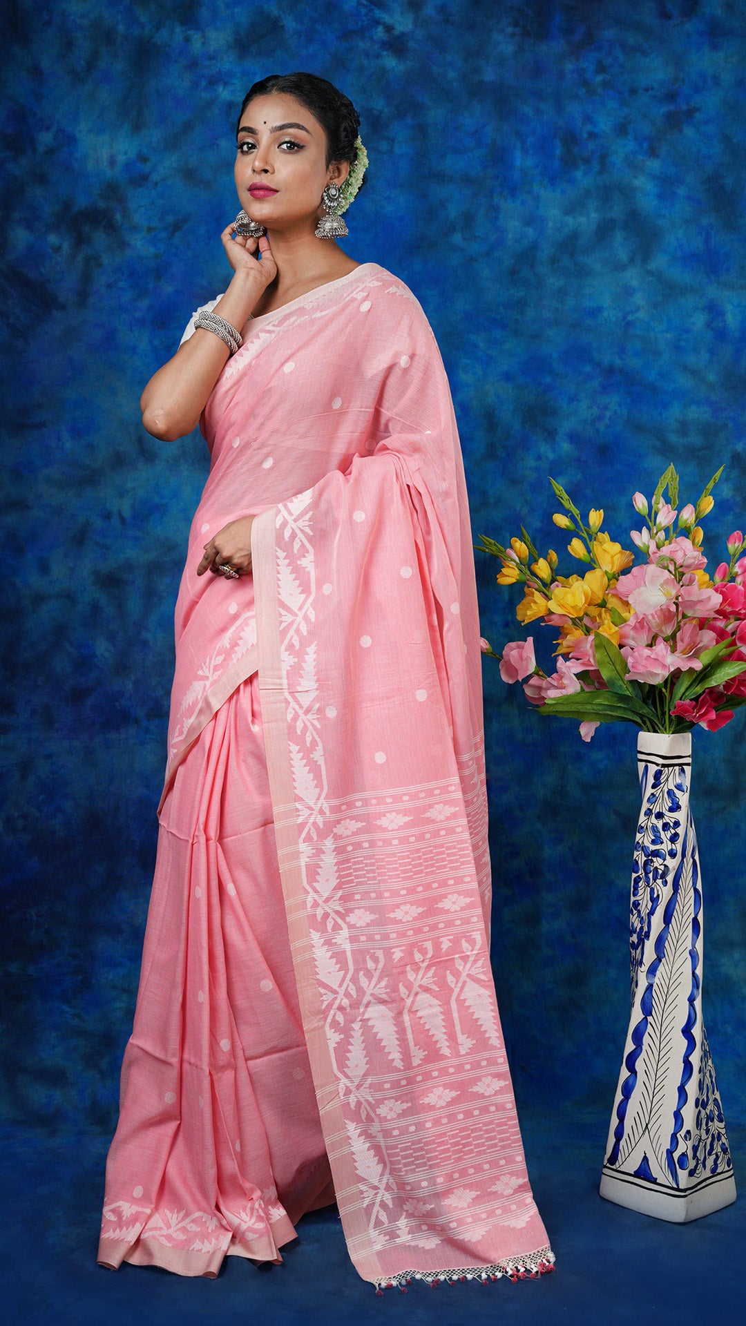 A light peach colour dhakai saree