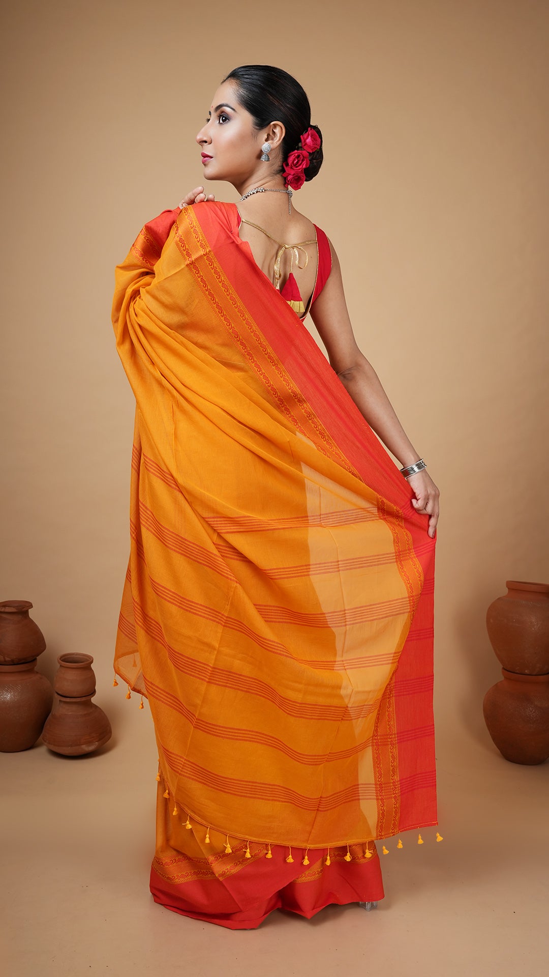 A golden yellow tangail saree