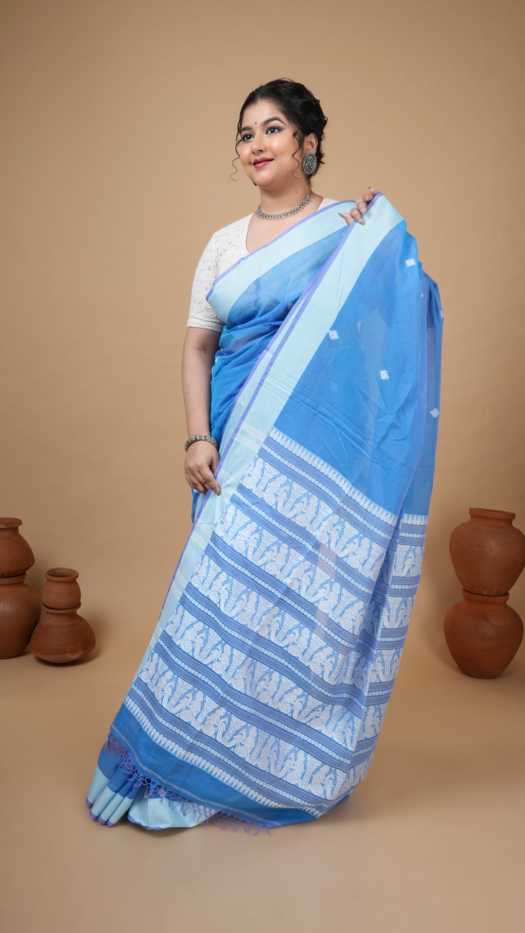 A blue and white tangail saree