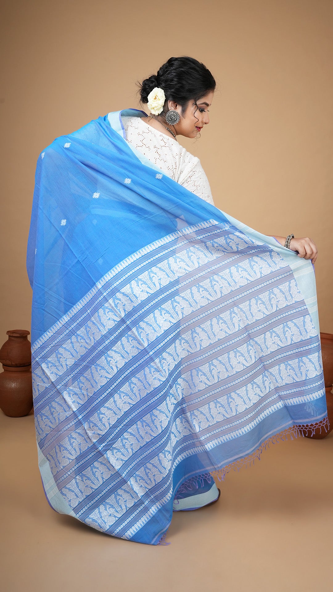 A blue and white tangail saree
