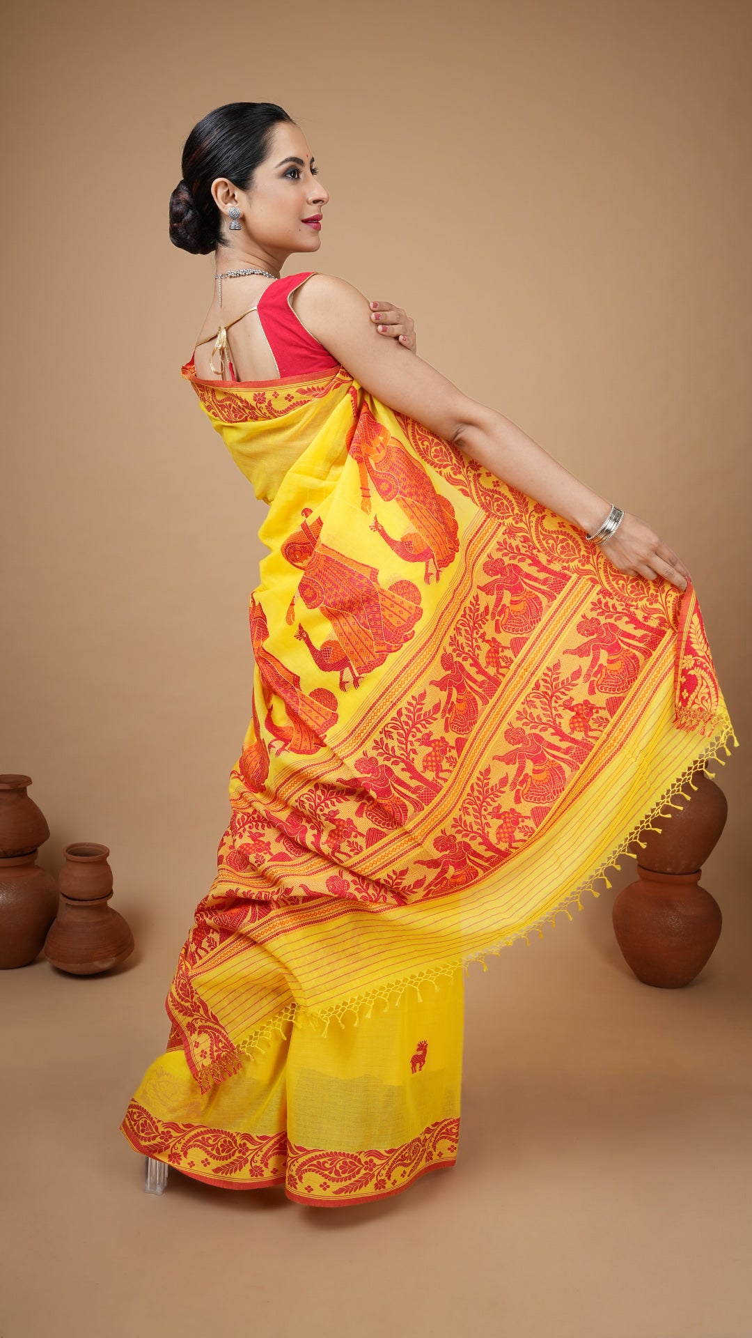A bright yellow tangail saree