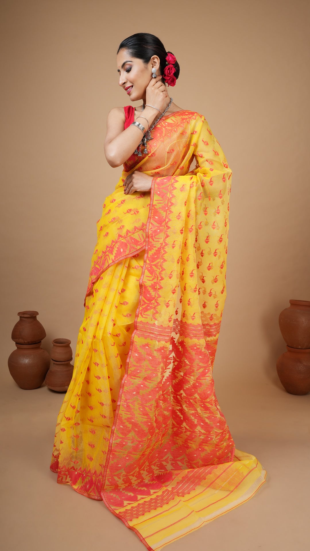 Muslin silk jamdani saree in yellow with red woven motifs on border, butis, and pallu. Luxurious wedding saree in traditional jamdani style.