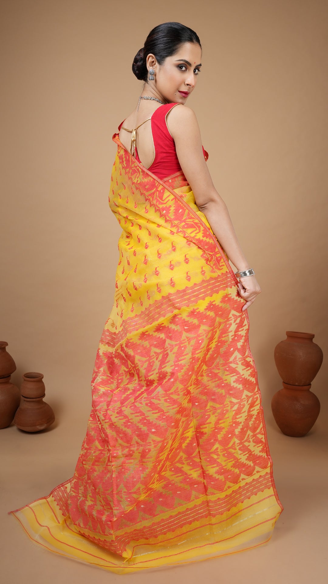 An yellow and red jamdani saree