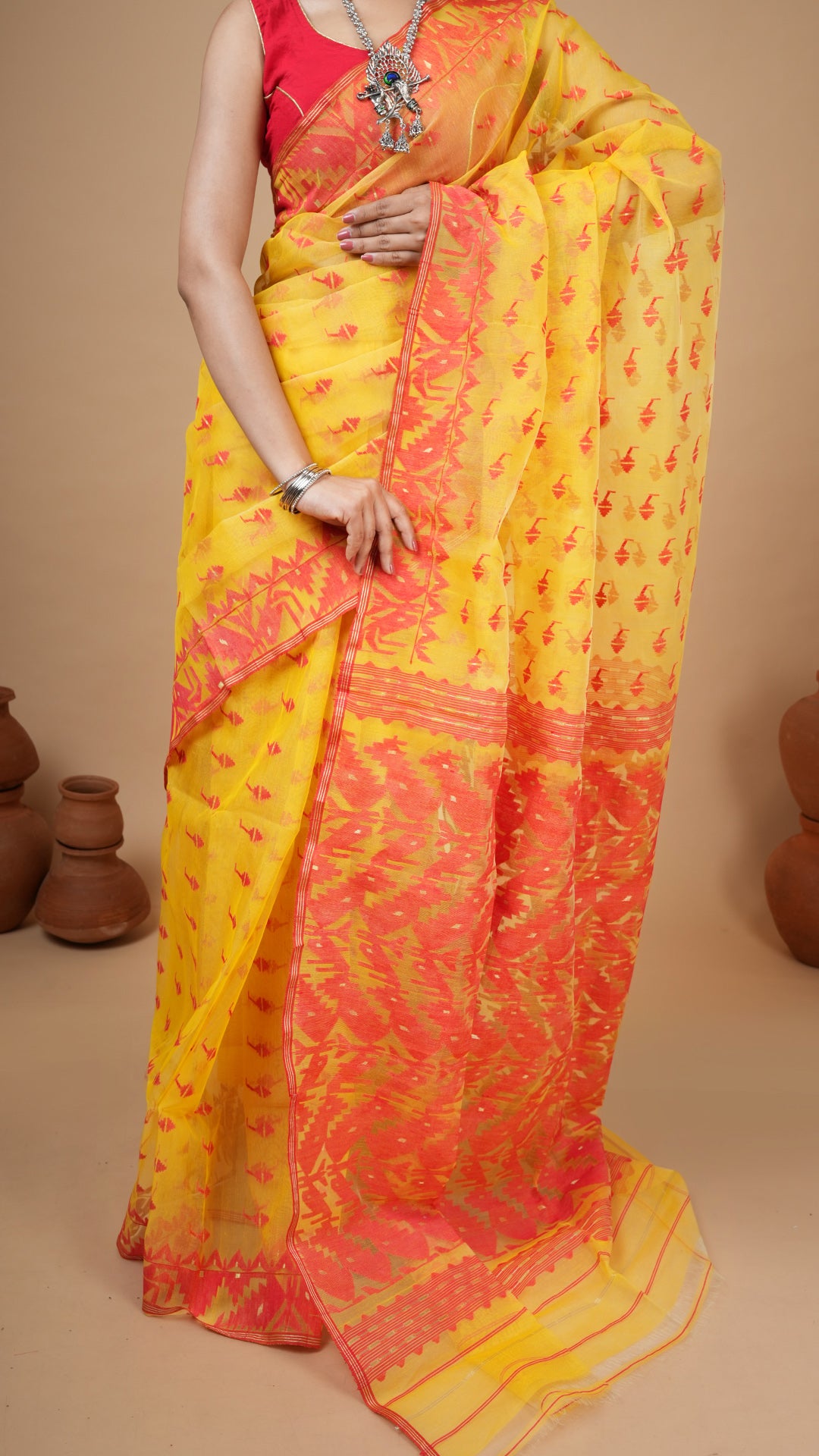 An yellow and red jamdani saree