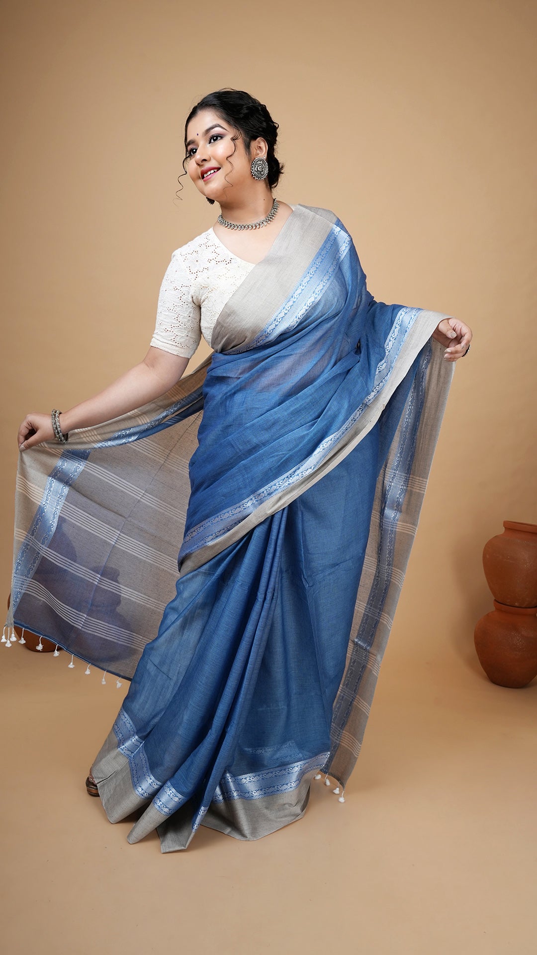 Short blue soft cotton tangail saree with beige flat border and vertical striped pallu. No butis. Lightweight saree for daily wear.