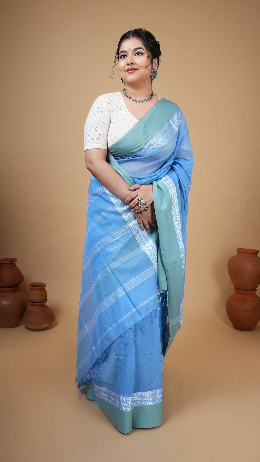 Sky blue soft cotton tangail saree with flat pesta border, white top weave and striped pallu. No butis. Subtle and graceful office saree.
