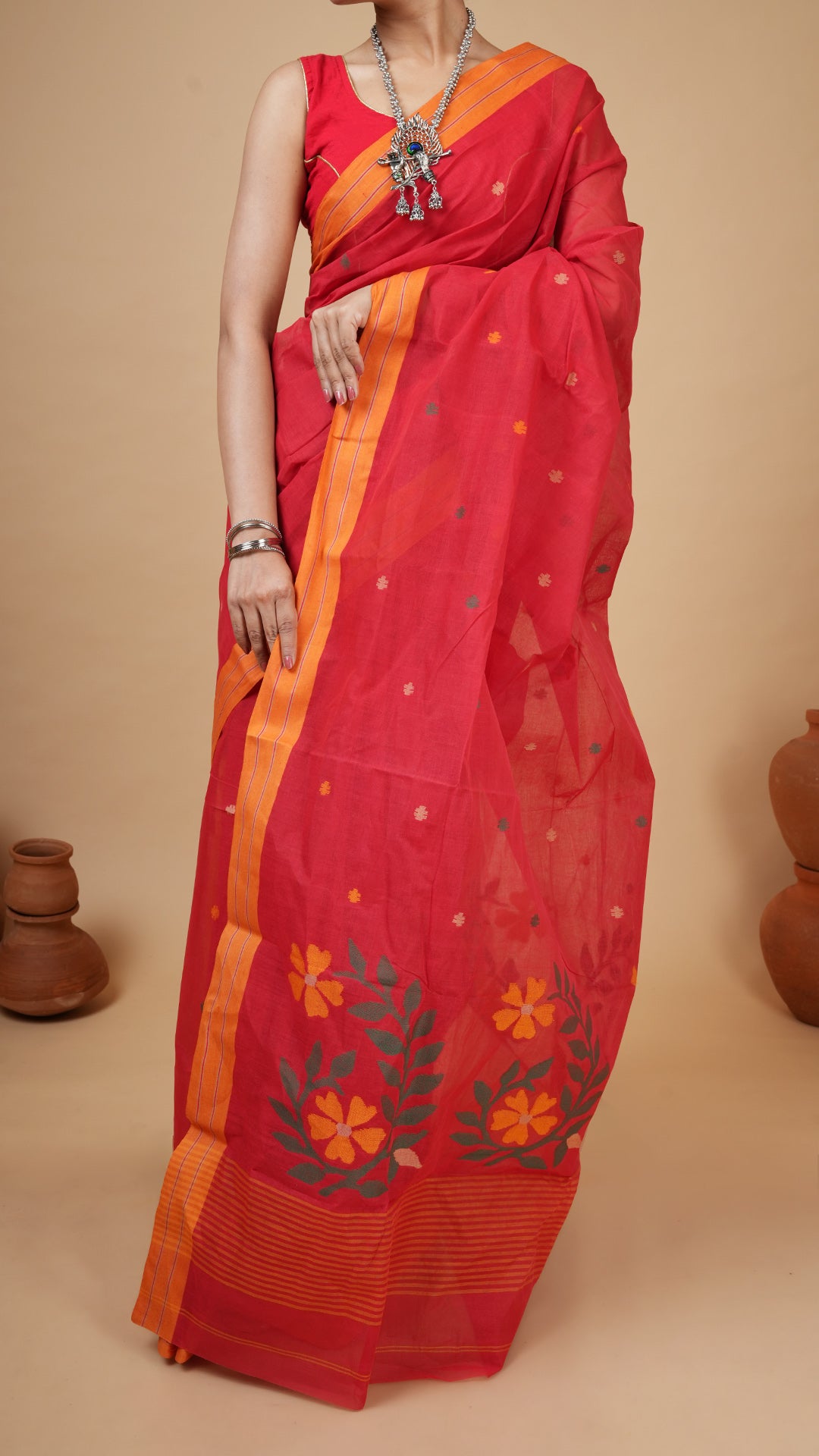 A red coloured dhakai saree