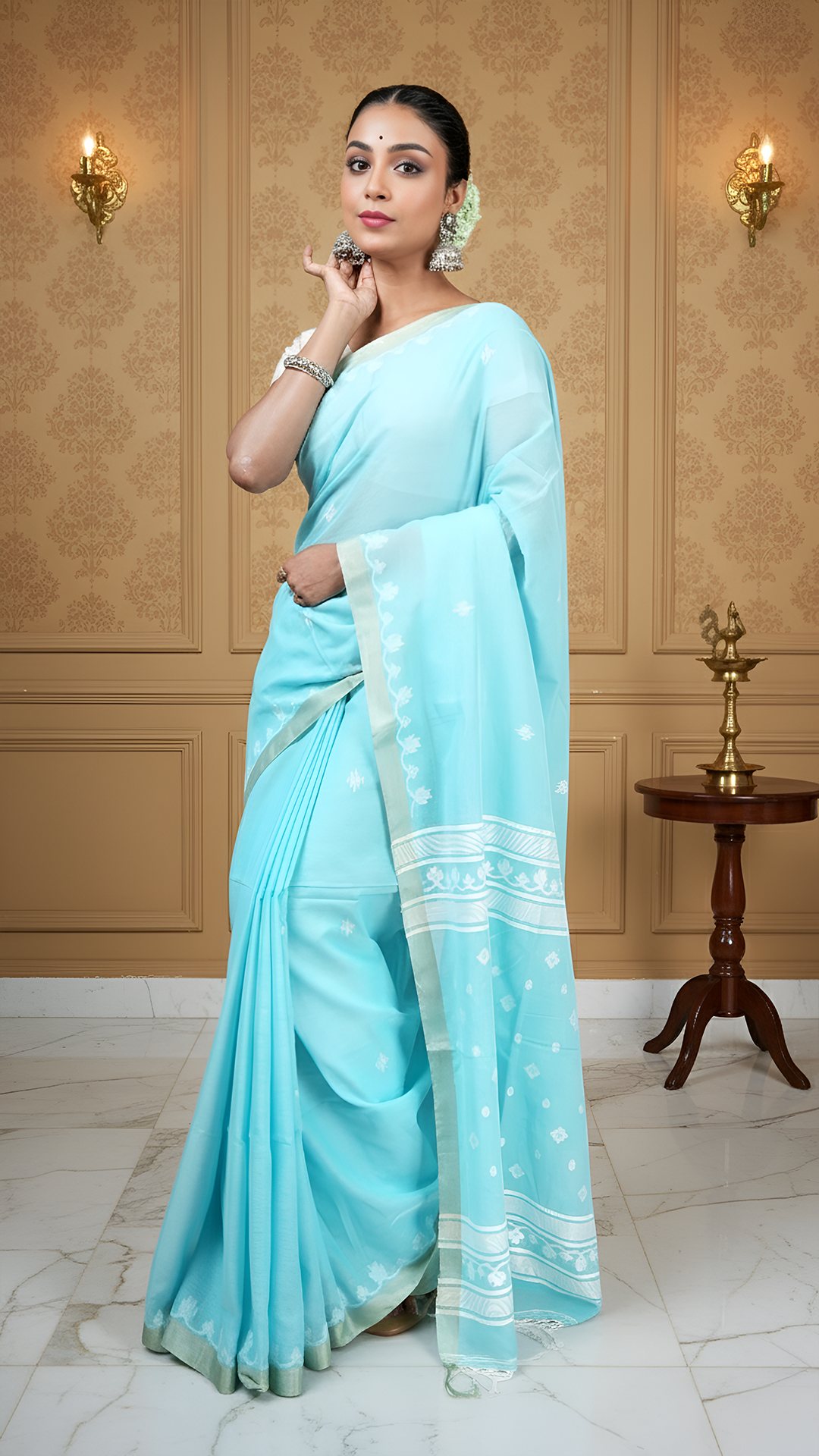 Firozi blue soft cotton tangail saree with white woven butis, pallu, and flat tassar border. Traditional saree for puja and gifting.