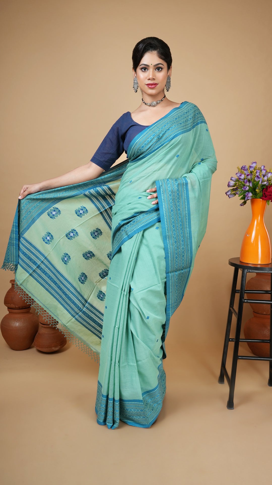 Green soft cotton tangail saree with blue woven border, butis, and pallu. Perfect for regular wear, office or gifting.