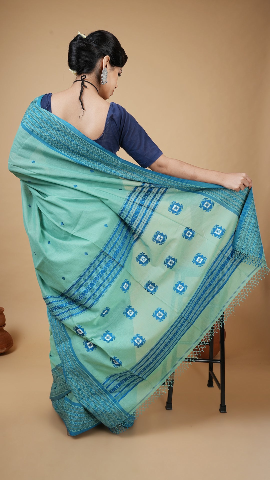 A green and blue tangail saree