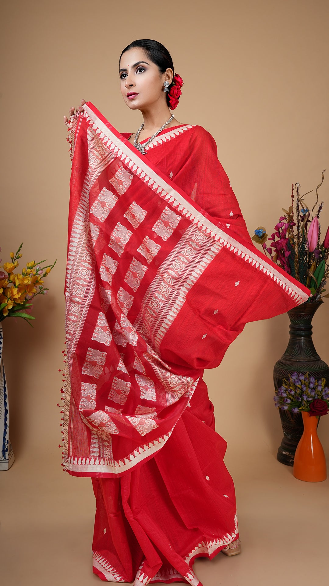 Red raw silk saree with off-white woven butis and muslin silk pallu. Premium party or puja wear.