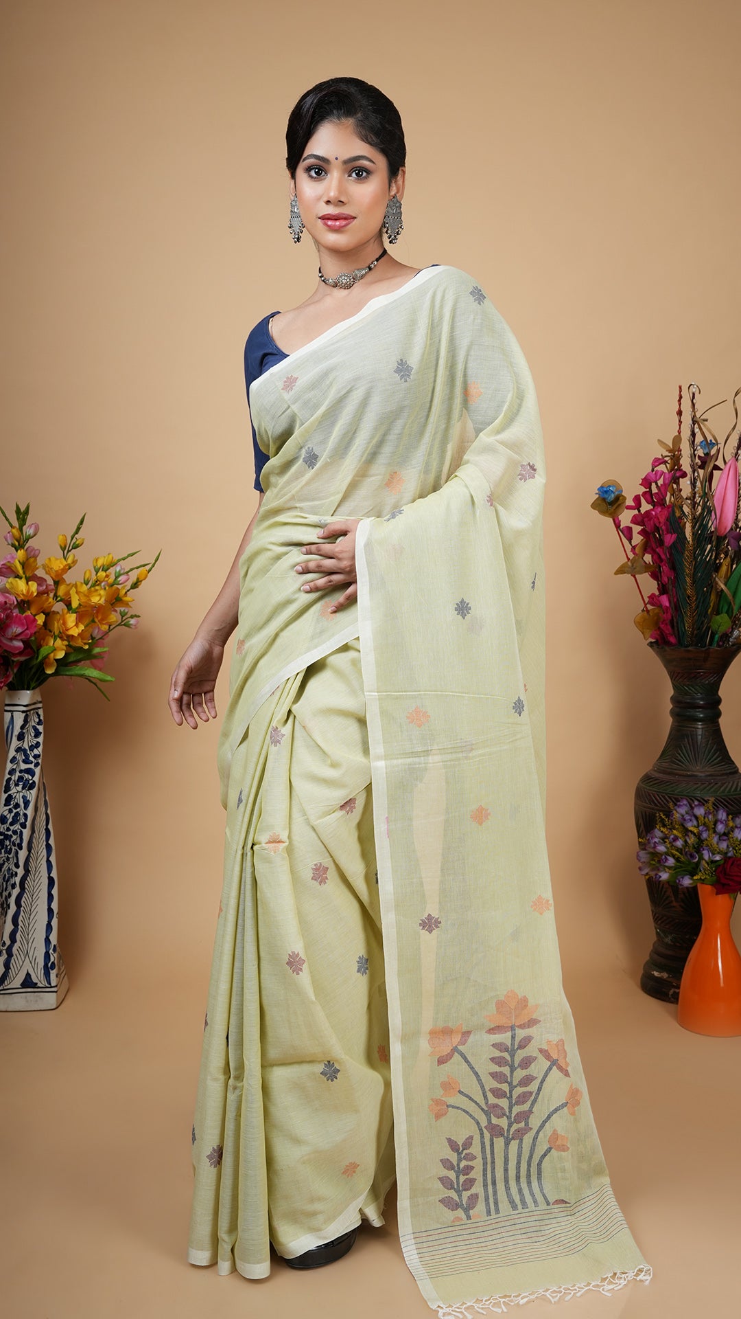 Pale pesta dhakai soft cotton saree with chocolate, mustard and midnight blue woven motifs on butis and pallu. No border. Subtle traditional wear.