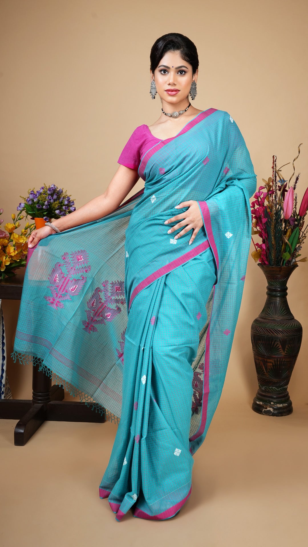 Sea green tangail soft cotton saree with magenta checks, flat border and woven butis and pallu in magenta and white.