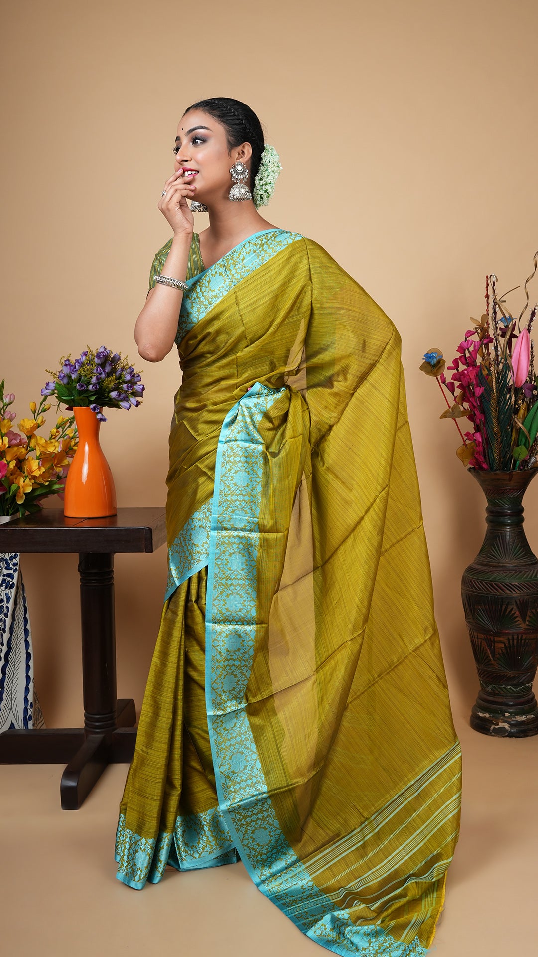 Dark olive silk tangail saree with firozi woven border and striped pallu. No butis. Elegant saree for party or wedding wear.
