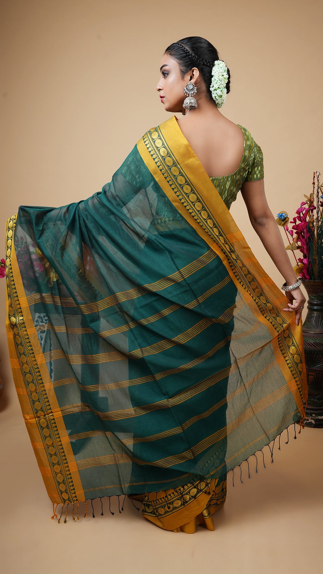 A deep green tangail saree