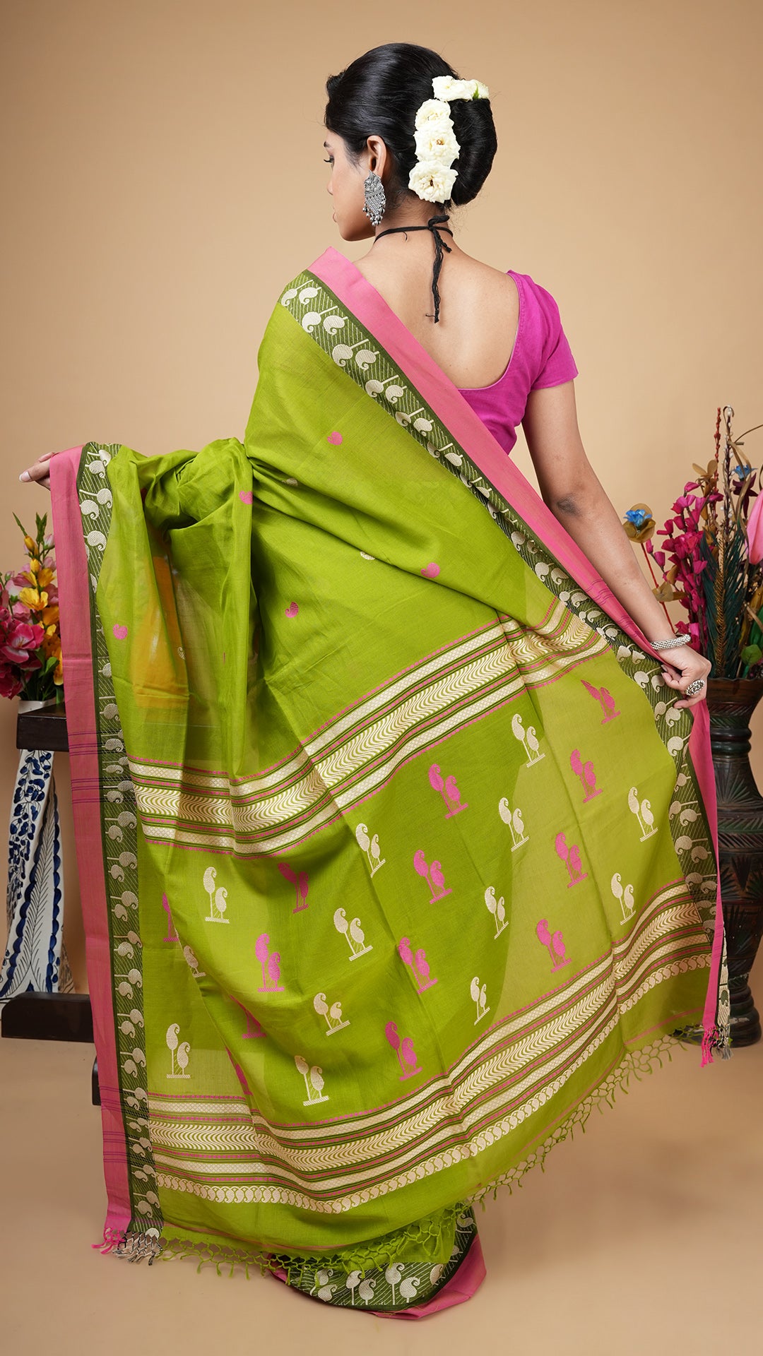 A green and pink tangail saree