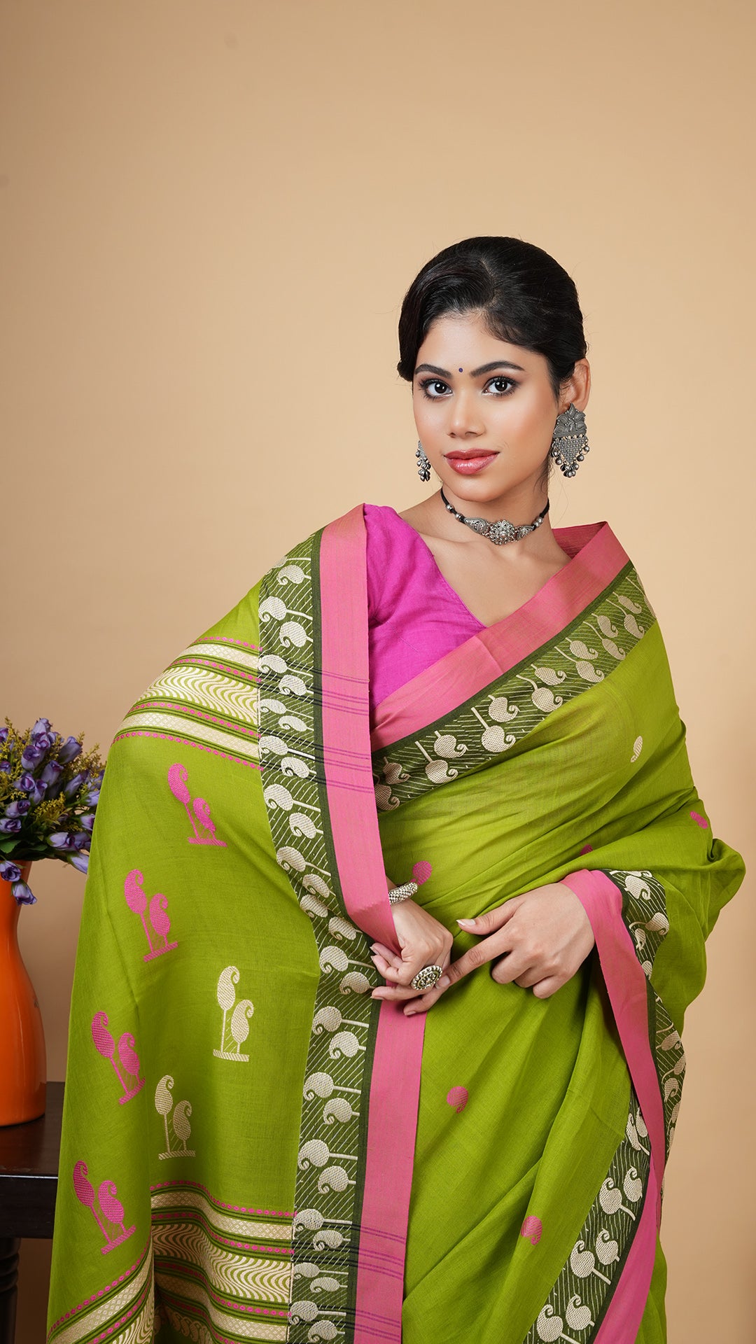 A green and pink tangail saree