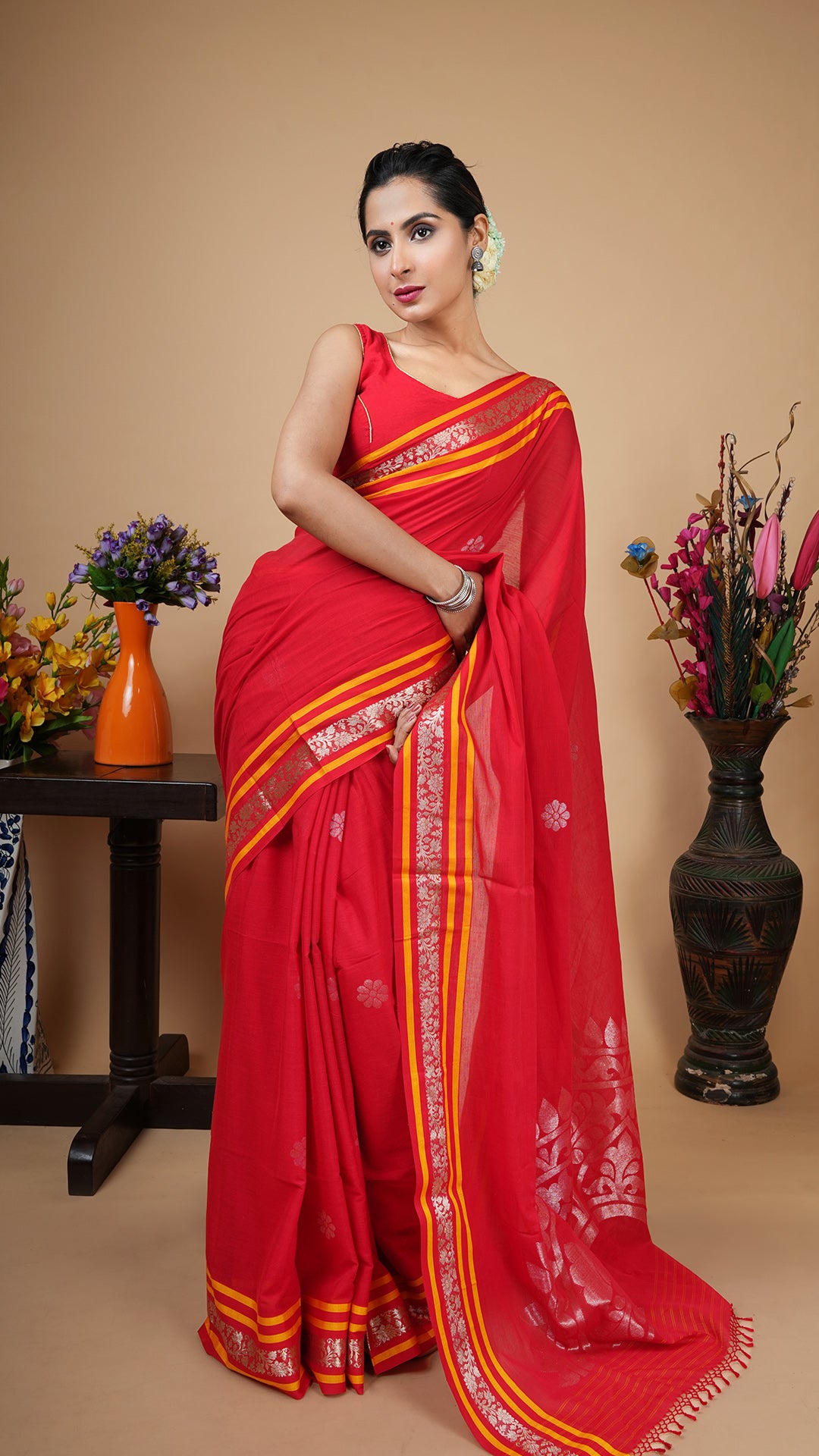 Red soft cotton tangail saree with gold woven border, yellow stripes and golden zari butis and pallu. Ideal wedding saree.