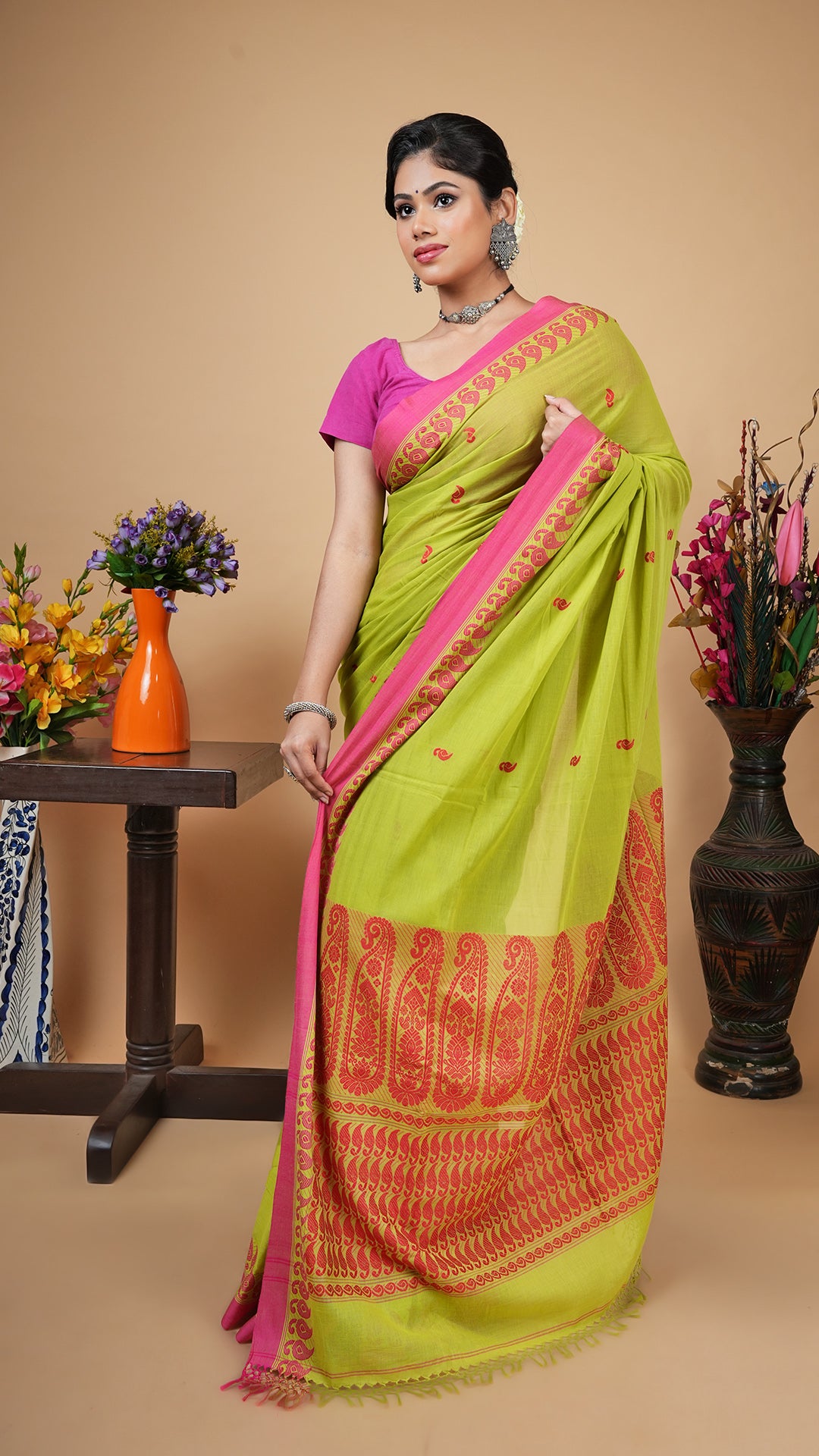 Green tangail soft cotton saree with pink woven border, butis and pallu. Suitable for office, daily wear or puja.