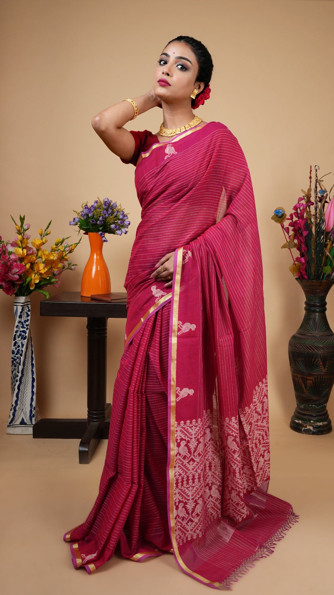 Maroon Tangail soft cotton saree with flat golden zari border and bird motifs, golden-striped body, and bird motif pallu. Beautiful festive and wedding wear.