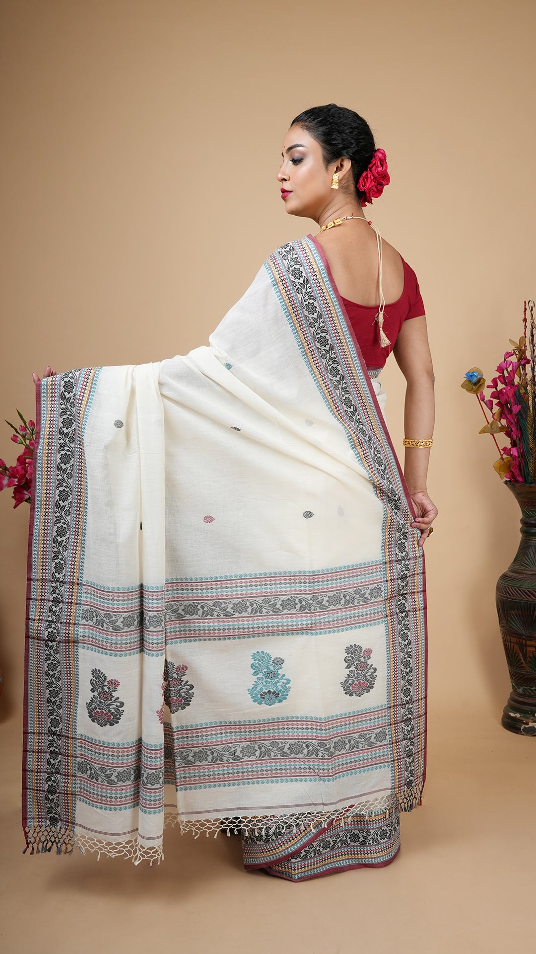 An off white tangail saree in soft cotton