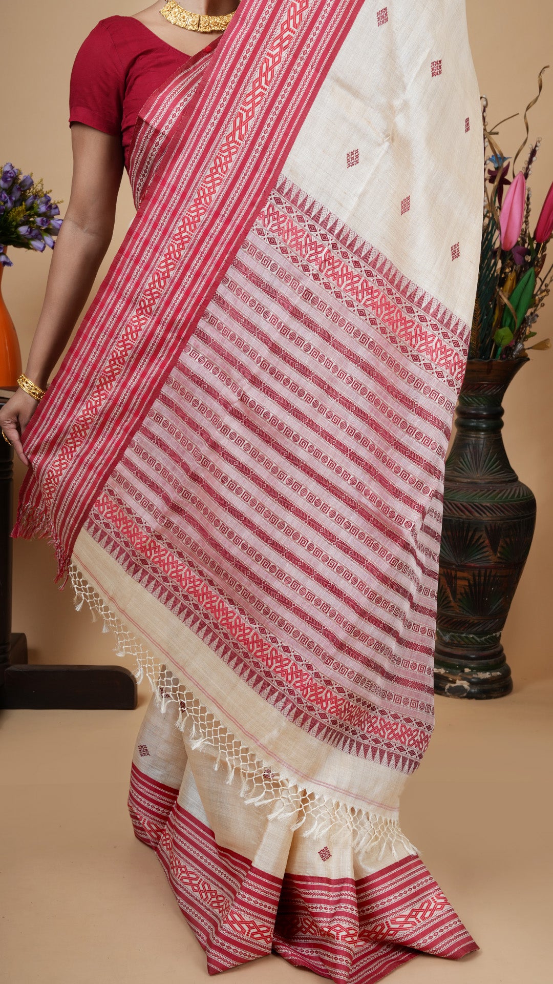 Tassar saree with red and maroon Tangail weave, detailed pallu design with intricate geometric patterns and handcrafted tassels, traditional Indian handloom saree